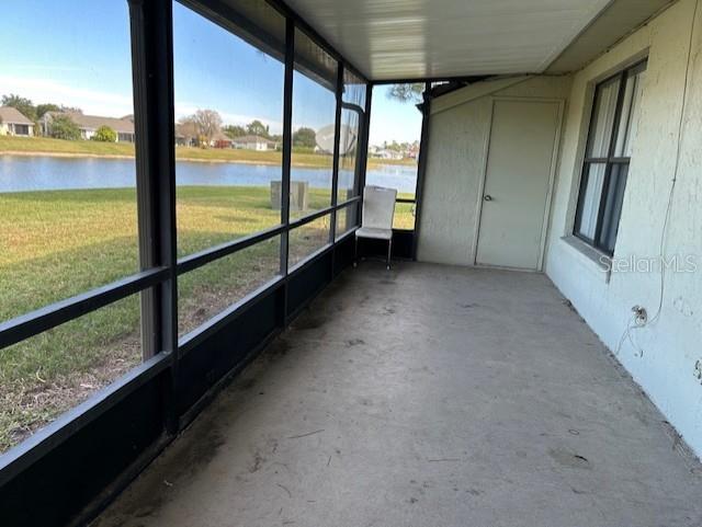 unfurnished sunroom featuring a healthy amount of sunlight and a water view