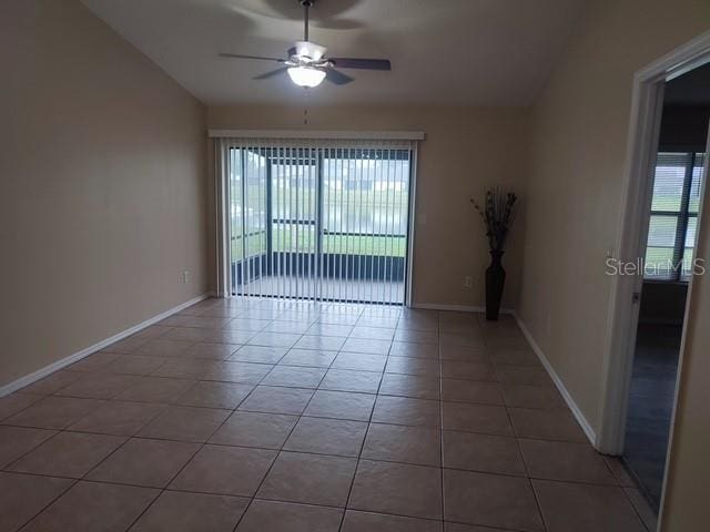 unfurnished room with lofted ceiling, plenty of natural light, and light tile patterned floors