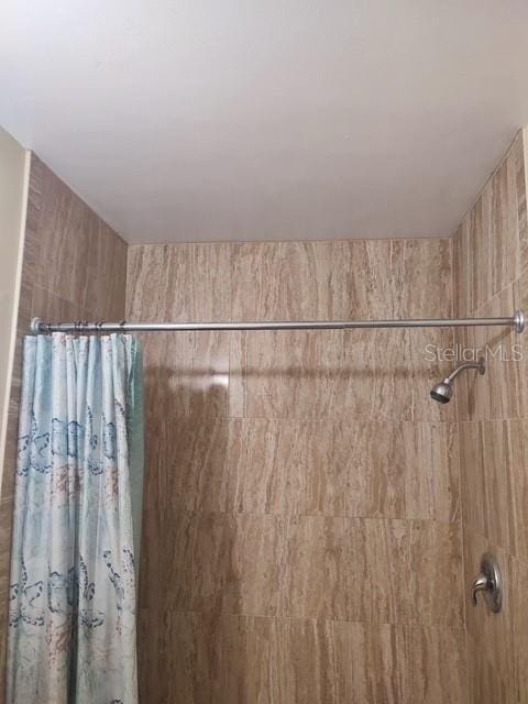 full bathroom with tiled shower