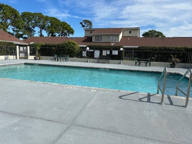 pool featuring a patio area and fence