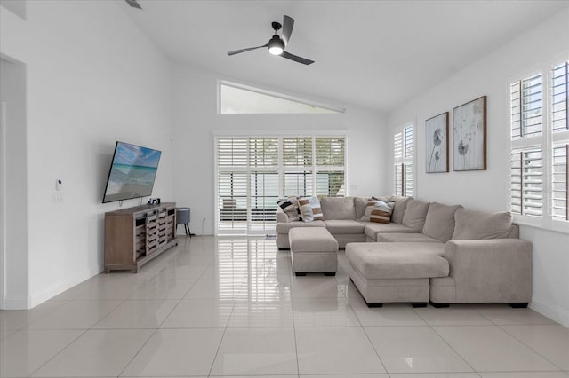 tiled living room featuring ceiling fan and vaulted ceiling