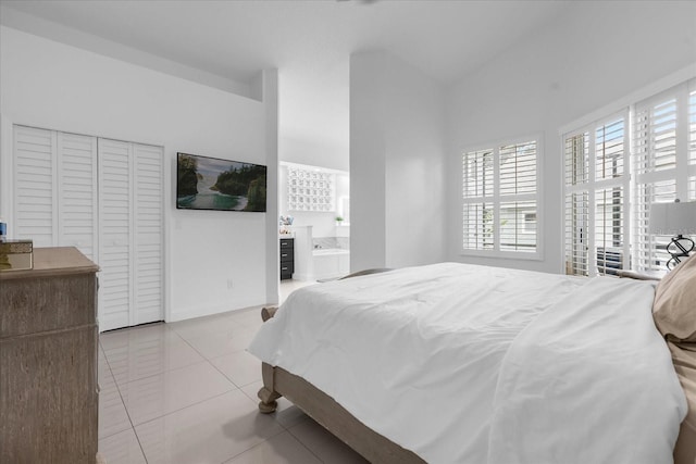 bedroom featuring light tile patterned floors and ensuite bathroom