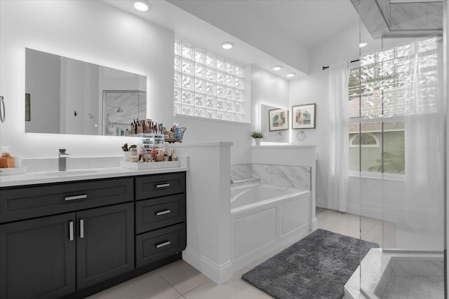 bathroom with vanity, tile patterned flooring, and a bathtub