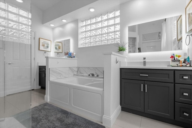 bathroom featuring vanity, tile patterned floors, and a bathtub