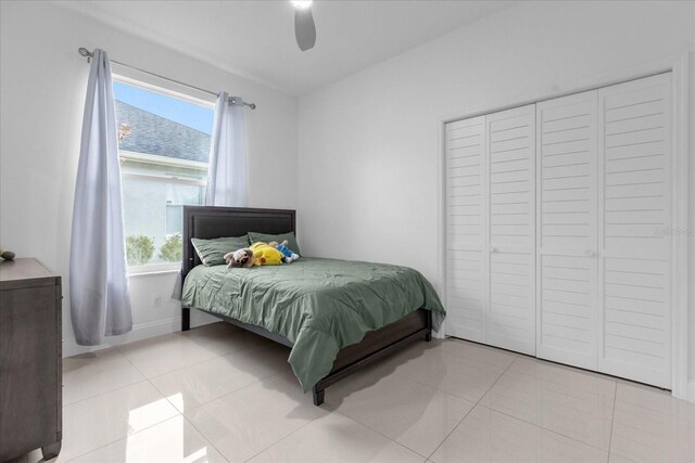 bedroom with ceiling fan and light tile patterned flooring