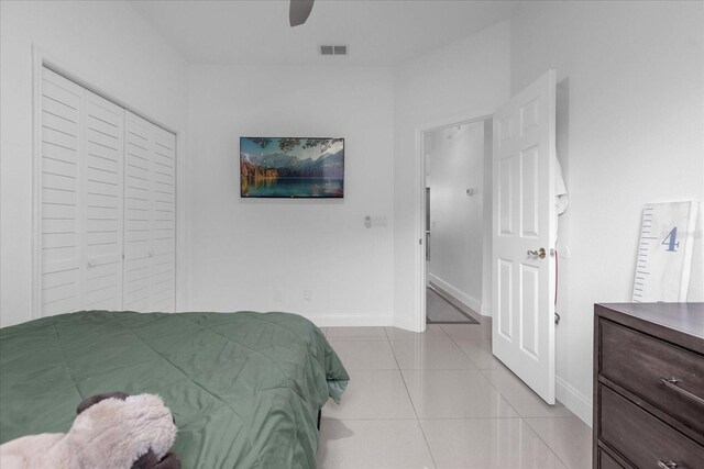 tiled bedroom featuring a closet and ceiling fan