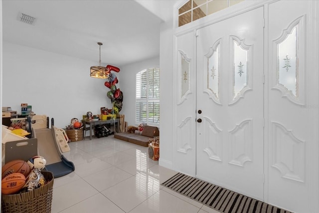 entryway with light tile patterned flooring