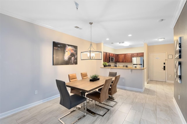 dining space featuring crown molding and a notable chandelier