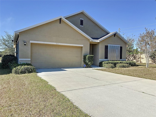 view of front of home with a garage and a front lawn