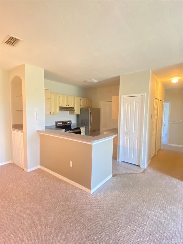 kitchen featuring kitchen peninsula, light carpet, and stainless steel appliances