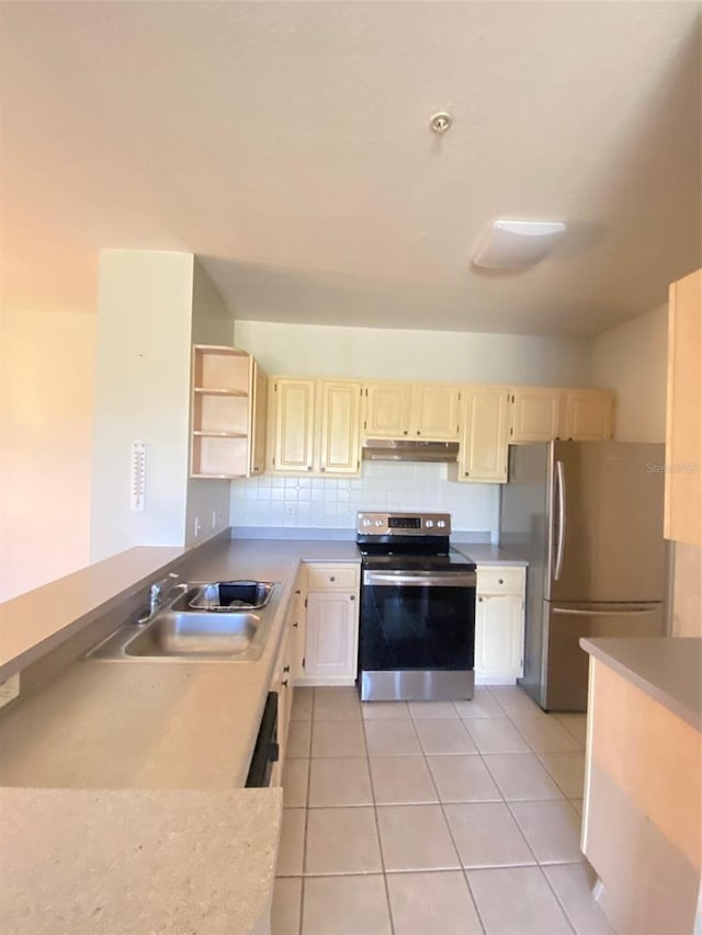 kitchen featuring decorative backsplash, sink, light tile patterned flooring, and stainless steel appliances