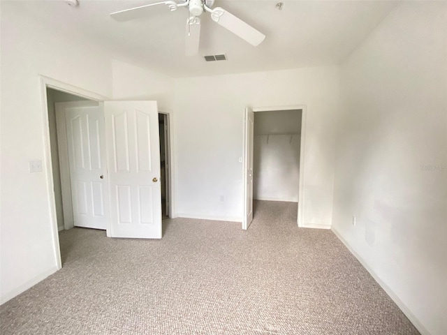 unfurnished bedroom with carpet flooring, ceiling fan, and a closet