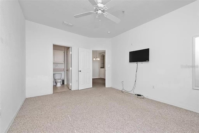 unfurnished bedroom featuring carpet, ceiling fan, and connected bathroom