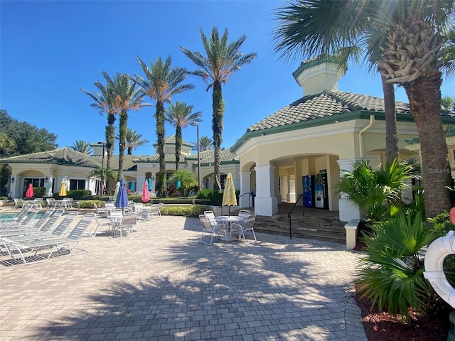 back of property featuring a patio area and a community pool