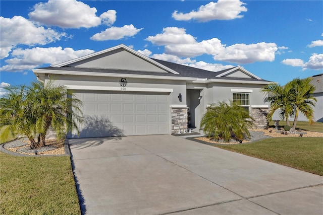 ranch-style home featuring a garage and a front yard