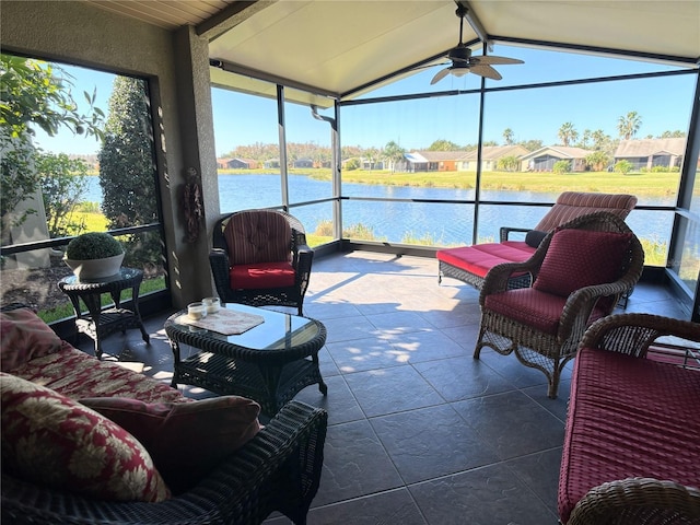 sunroom / solarium featuring ceiling fan, lofted ceiling with beams, and a water view