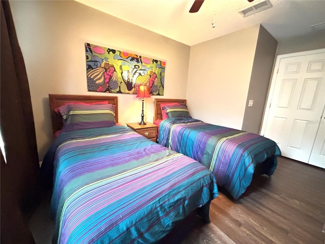 bedroom with ceiling fan and dark wood-type flooring