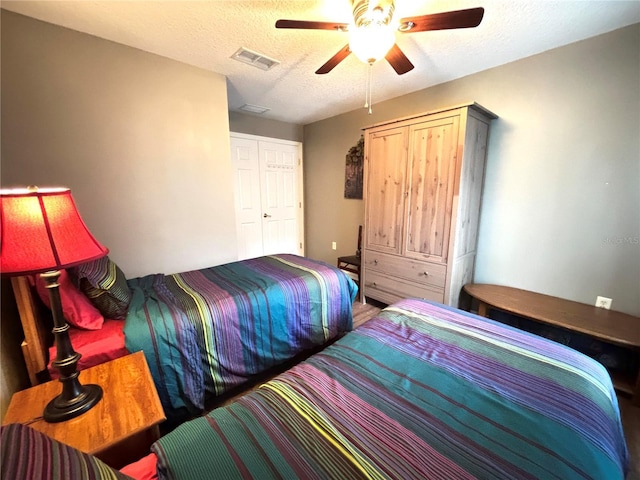 bedroom featuring ceiling fan and a textured ceiling