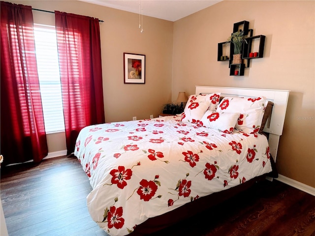 bedroom featuring hardwood / wood-style floors and multiple windows