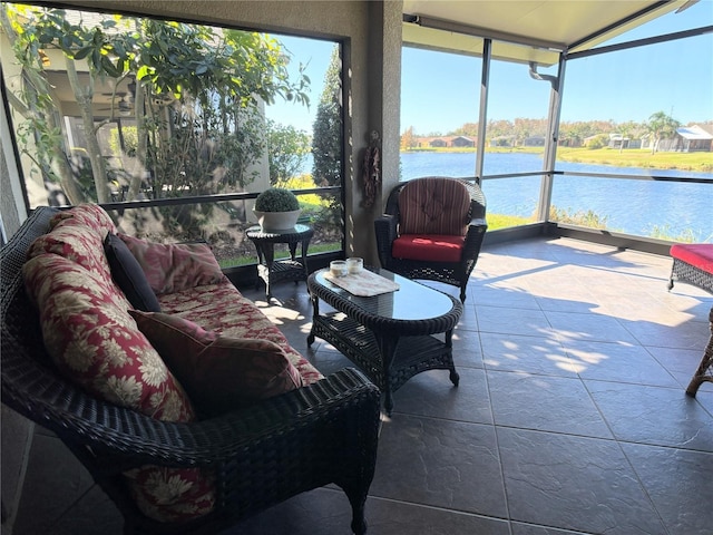 sunroom featuring a water view