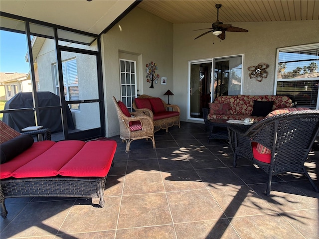 sunroom / solarium with ceiling fan and vaulted ceiling