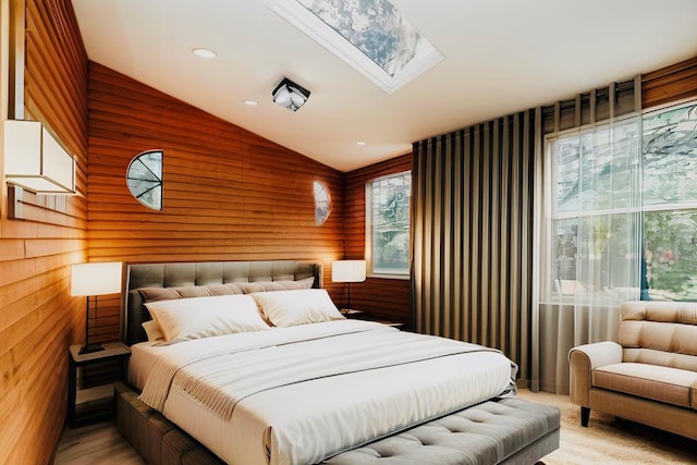 bedroom featuring vaulted ceiling with skylight, wood walls, and recessed lighting