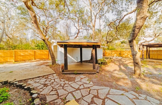 view of outbuilding with a fenced backyard and an outbuilding