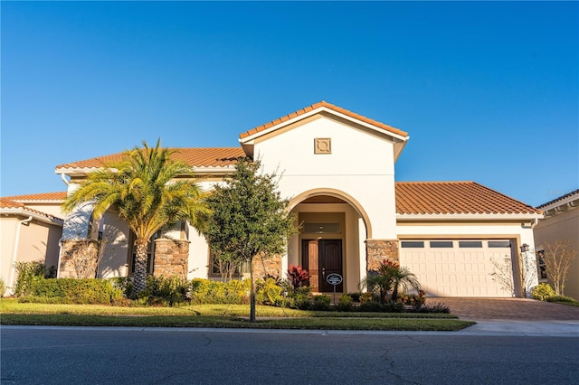 mediterranean / spanish house featuring a garage