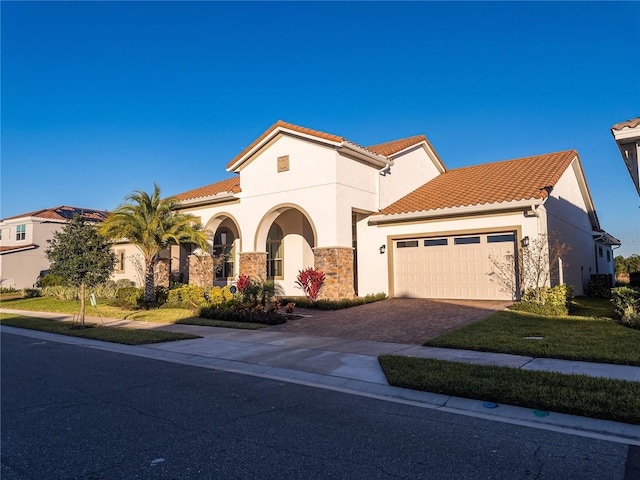 mediterranean / spanish-style home with a front yard and a garage