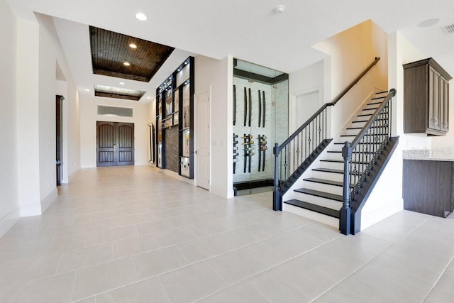 stairway featuring baseboards, tile patterned floors, visible vents, and recessed lighting