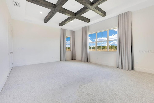 spare room with light colored carpet, coffered ceiling, beamed ceiling, and visible vents