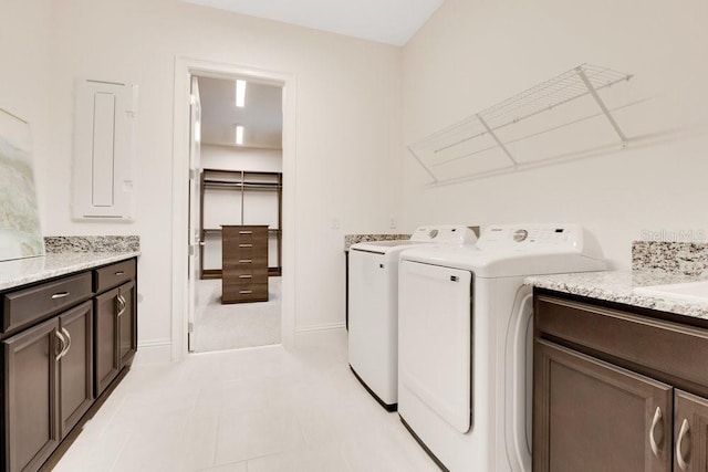 washroom with cabinet space, washer and clothes dryer, and baseboards