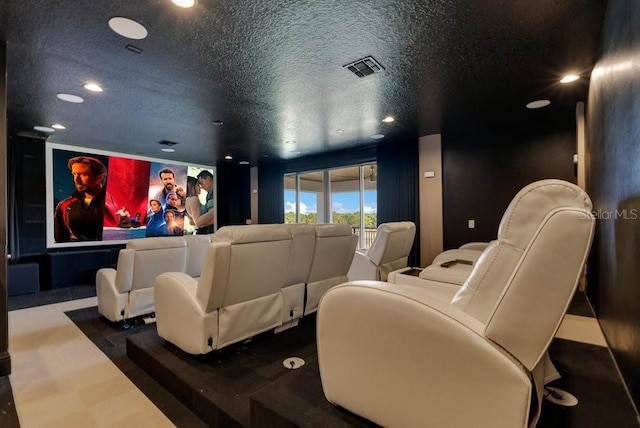 cinema room with recessed lighting, visible vents, and a textured ceiling