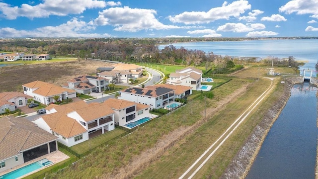 drone / aerial view featuring a residential view and a water view