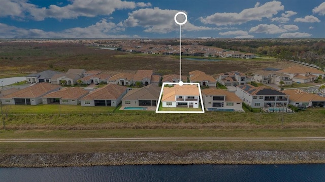 bird's eye view with a water view and a residential view