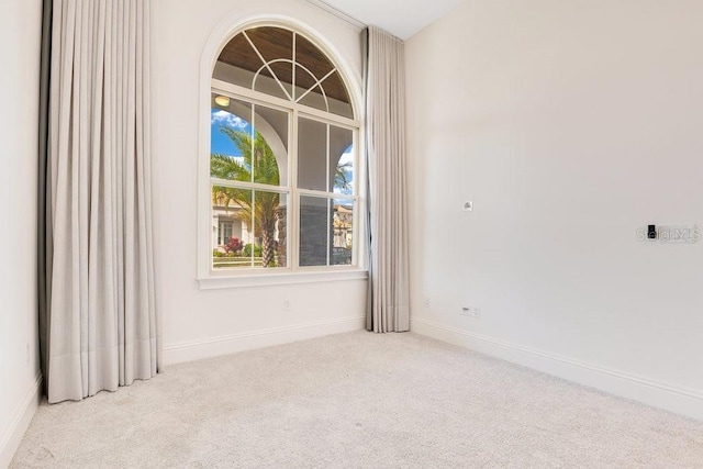 empty room with light carpet and baseboards