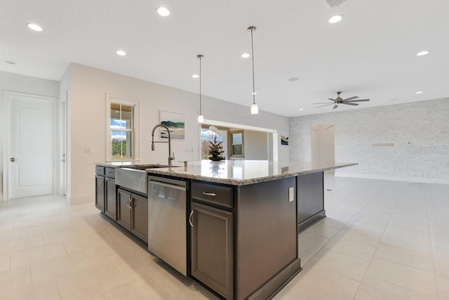 kitchen featuring a sink, a center island with sink, dishwasher, and decorative light fixtures