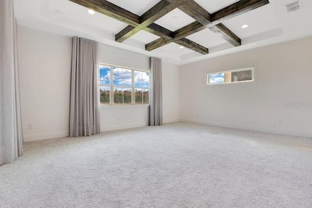 unfurnished room featuring coffered ceiling, a wealth of natural light, beam ceiling, and visible vents