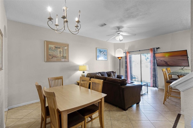 dining space featuring a textured ceiling, light tile patterned floors, and ceiling fan with notable chandelier