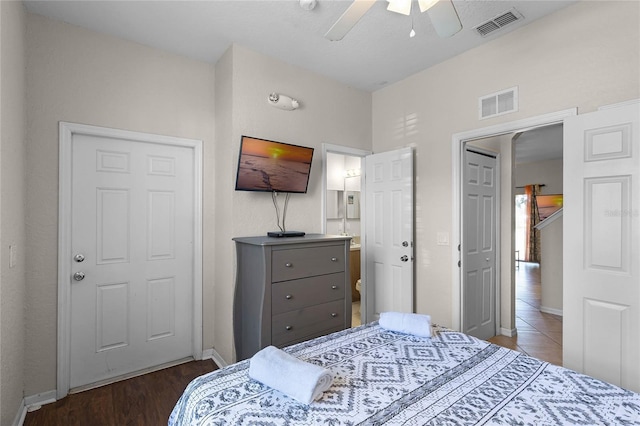 bedroom with ceiling fan, dark hardwood / wood-style flooring, and ensuite bathroom