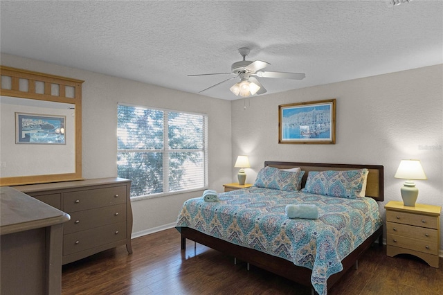 bedroom featuring dark hardwood / wood-style floors, ceiling fan, and a textured ceiling