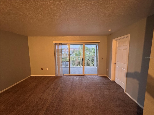 carpeted empty room featuring a textured ceiling