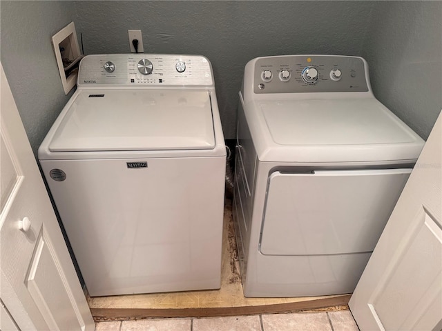 clothes washing area with separate washer and dryer