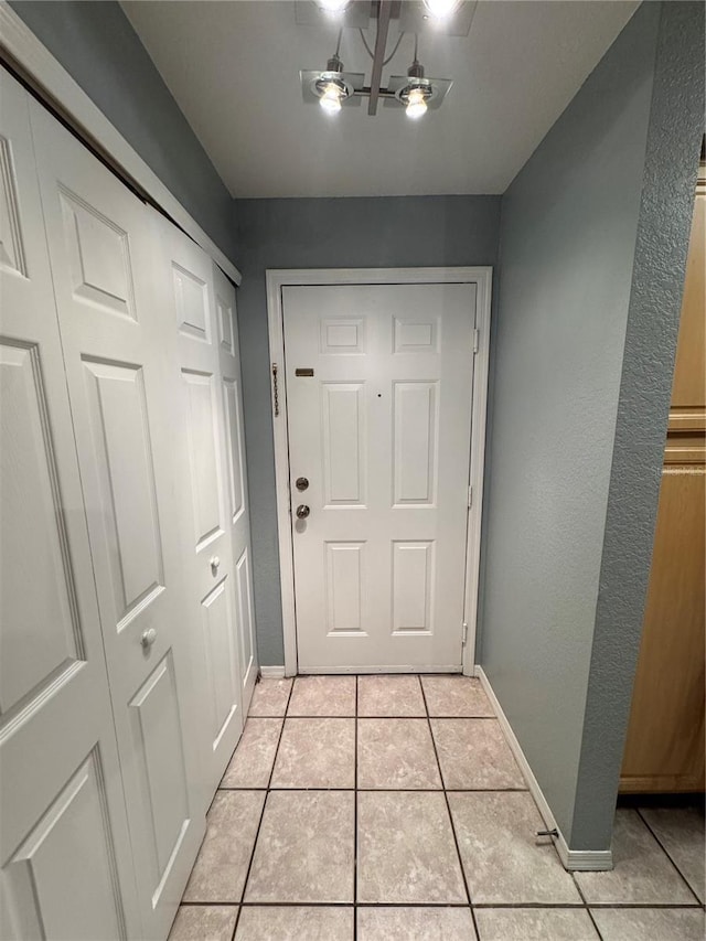 doorway with light tile patterned floors