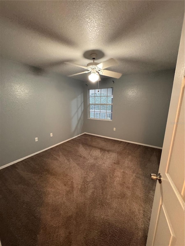 empty room with carpet flooring, a textured ceiling, and ceiling fan