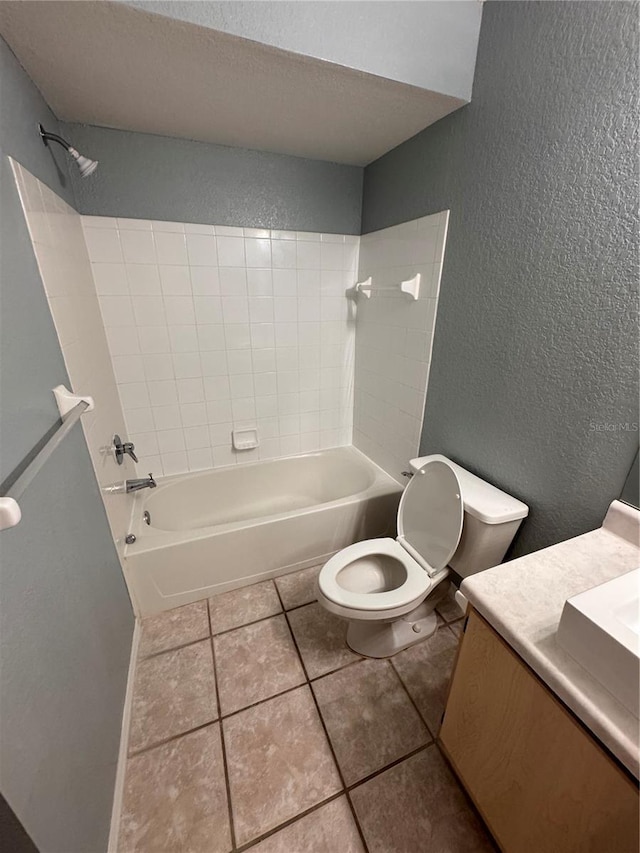 full bathroom with tile patterned flooring, tiled shower / bath combo, vanity, a textured ceiling, and toilet