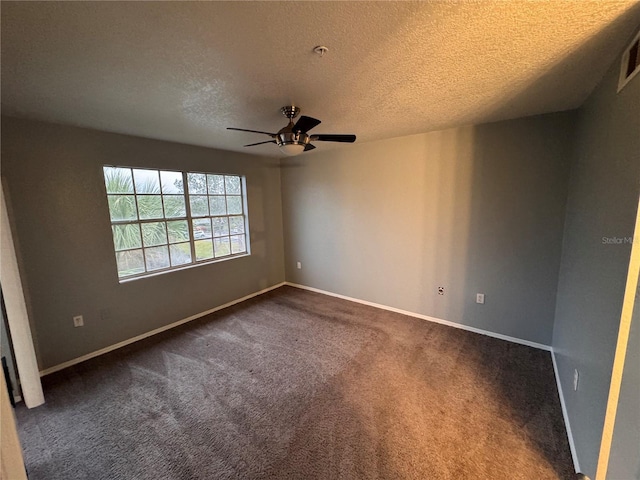 unfurnished room with ceiling fan, a textured ceiling, and dark colored carpet