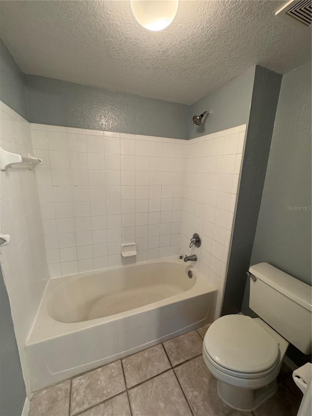 bathroom featuring a textured ceiling, tile patterned floors, shower / bathtub combination, and toilet