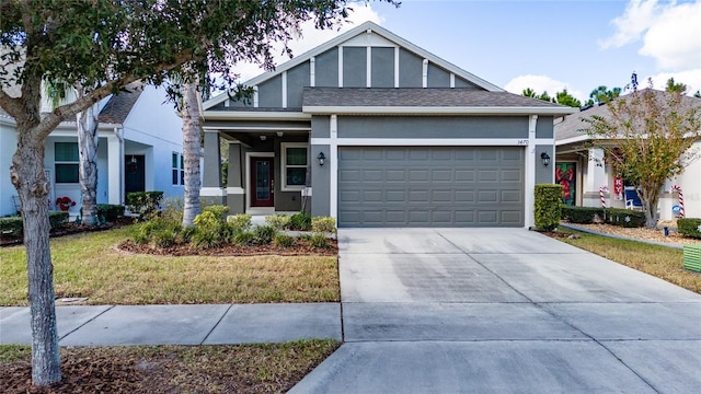 view of front of property with a front yard and a garage