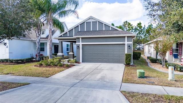 view of front of home with a front yard and a garage